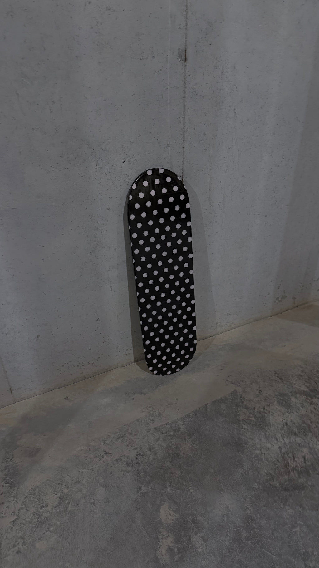 pink and black polka dot skateboard deck