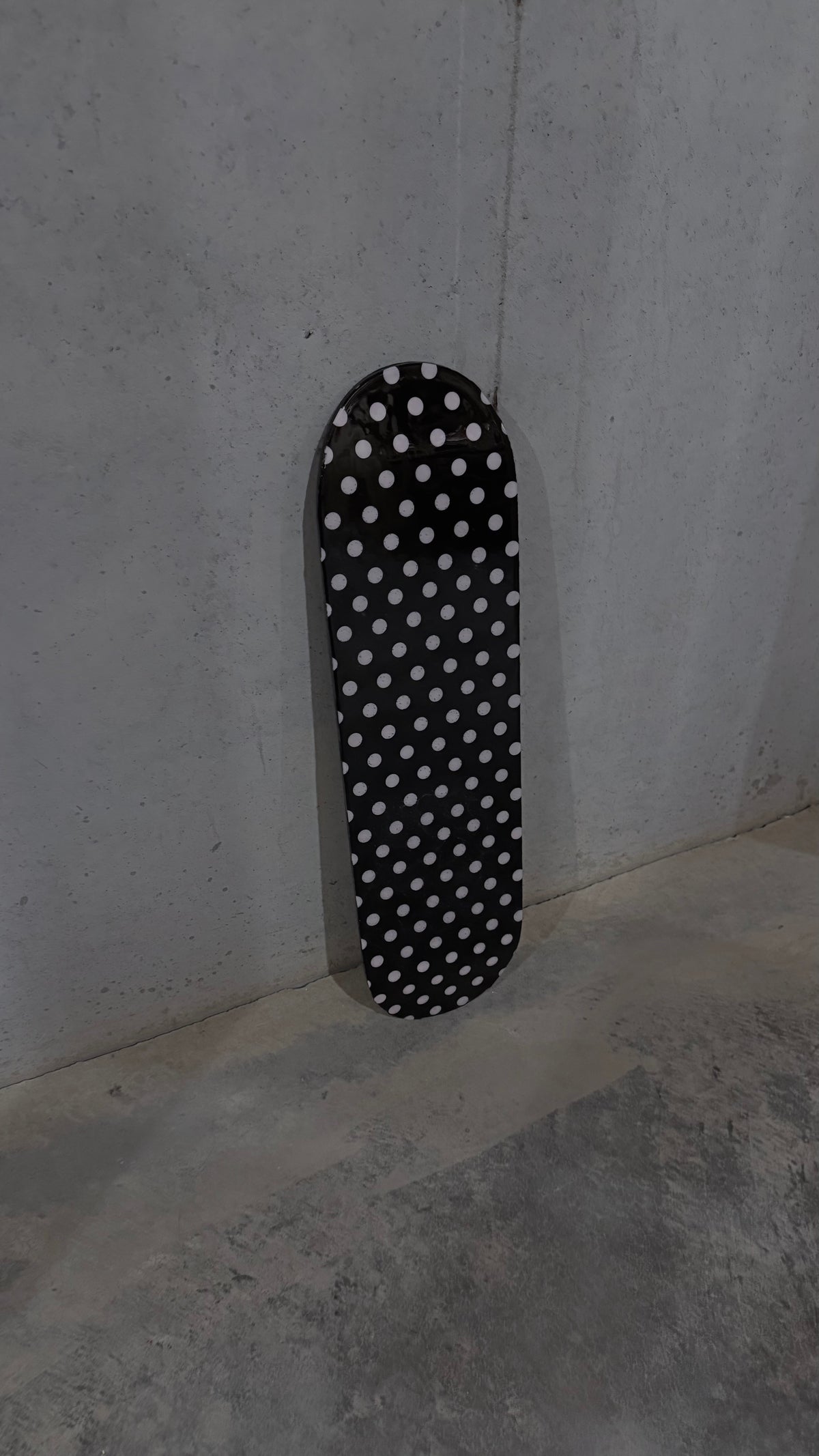 pink and black polka dot skateboard deck
